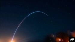 People at Jetty Park in Cape Canaveral, Florida, watch as Terran I, a 3D-printed rocket by Relativity Space, lifts off from Cape Canaveral Space Force Station. The first stage did its job following liftoff from Cape Canaveral Space Force Station and separated as planned. But the upper stage appeared to ignite and then shut down, sending it crashing into the Atlantic Ocean.