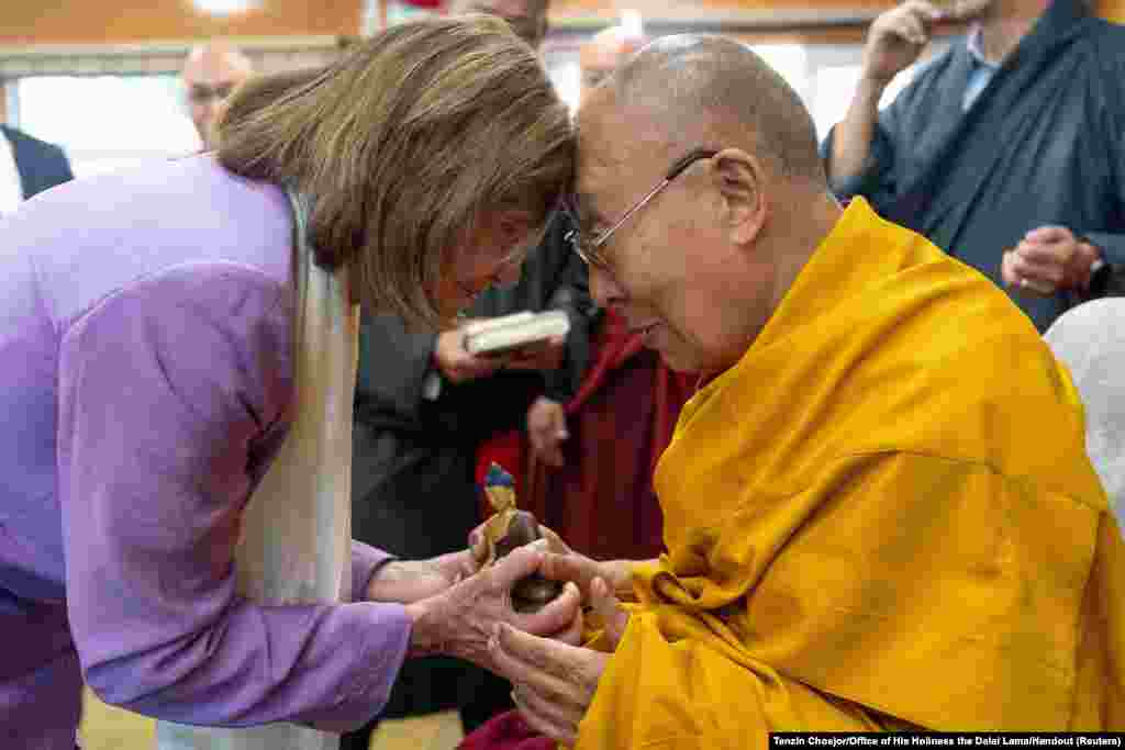 Tibetan spiritual leader the Dalai Lama exchanges greetings with former U.S. House Speaker Nancy Pelosi during their meeting at Dharamshala, Himachal Pradesh, India.