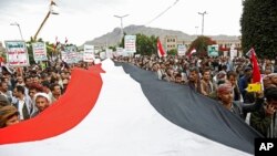Demonstrators chant slogans as they attend a rally on March 26, 2023, in Sanaa, Yemen. On July 22, 2023, police arrested two suspects in the killing of a World Food Program official.