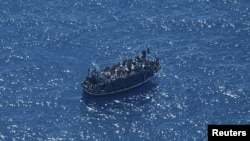 A boat in distress with about 400 people on board is pictured in the Mediterranean Sea in this handout obtained by Reuters on April 10, 2023. (Giacomo Zorzi/Sea-Watch/Handout via Reuters)