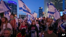 Israelis protest plans by Prime Minister Benjamin Netanyahu's government to overhaul the judicial system in Tel Aviv, Israel, April 22, 2023. (AP Photo/Tsafrir Abayov)
