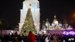 People take photographs as they attend the lighting ceremony for the Christmas tree on Sophia Square in Kyiv, Dec. 6, 2023, amid the Russian invasion of Ukraine.