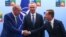 Turkey's President Recep Tayyip Erdogan, left, shakes hands with Sweden's Prime Minister Ulf Kristersson, right, as NATO Secretary General Jens Stoltenberg looks on prior to a meeting ahead of a NATO summit in Vilnius, Lithuania, July 10, 2023.