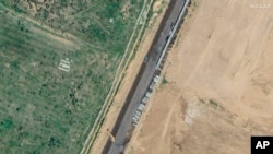 This satellite image provided by Maxar Technologies shows wall construction in Rafah, Egypt, Feb. 15, 2024. (Maxar Technologies via AP)