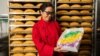 Huong Tran, owner of Dong Phuong Bakery, shows her popular king cake during Mardi Gras 2021 at the bakery in New Orleans. 
