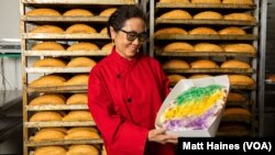 Huong Tran, owner of Dong Phuong Bakery, shows her popular king cake during Mardi Gras 2021 at the bakery in New Orleans. 