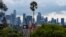 Low clouds gather over the Los Angeles skyline seen from Elysian Park ahead of forecasted rain in Los Angeles, Feb. 18, 2024. 