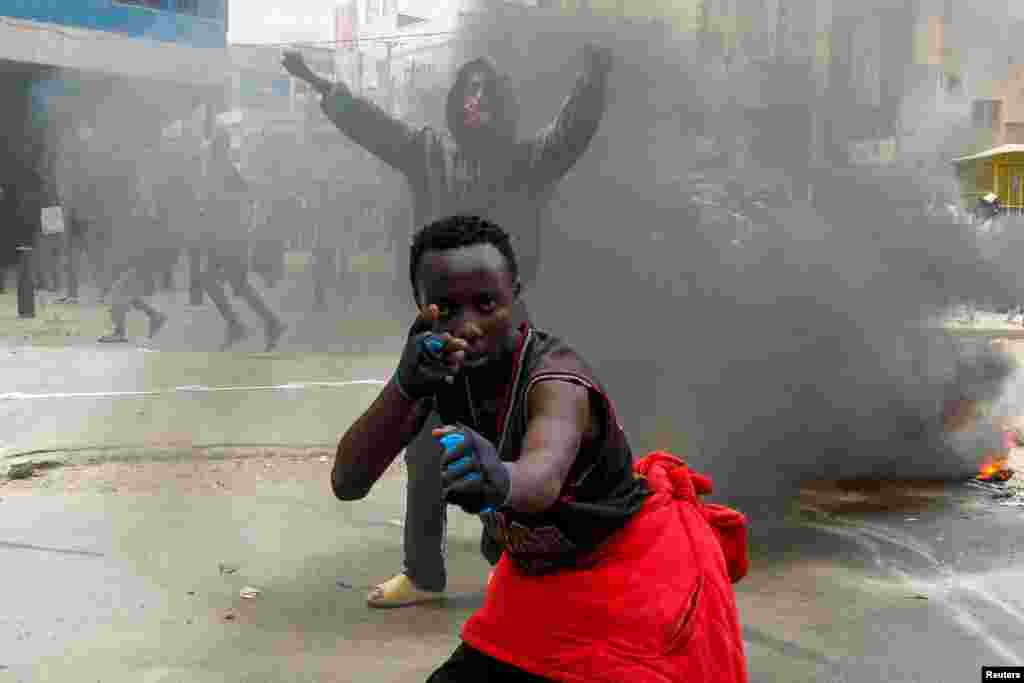 A man gestures during a demonstration over police killings of people protesting against the imposition of tax hikes by the government, in Nairobi, Kenya.