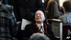 Former President Jimmy Carter greets people as he leaves after the funeral service for his wife, former first lady Rosalynn Carter, at Maranatha Baptist Church in Plains, Georgia, Nov. 29, 2023.