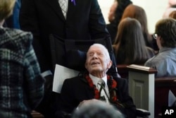 Former President Jimmy Carter greets people as he leaves after the funeral service for his wife, former first lady Rosalynn Carter, at Maranatha Baptist Church in Plains, Georgia, Nov. 29, 2023.