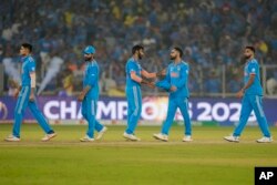 Indian players react after they lost to Australia by 6 wickets during the ICC Men's Cricket World Cup final match in Ahmedabad, Nov. 19, 2023.