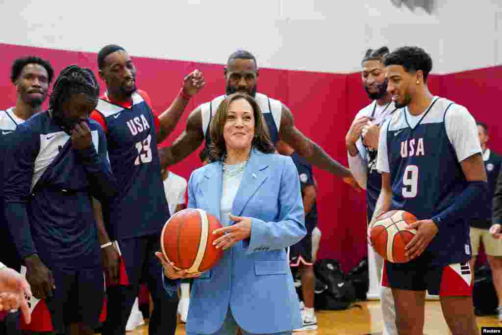 Basketball player LeBron James stands behind U.S. Vice President Kamala Harris as she meets with the U.S. men’s Olympic basketball team during a practice session, in Las Vegas, Nevada, July 9, 2024. 