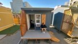 Eric Martinez sits outside of his room at a micro community in Denver on Wednesday, June 5, 2024. (AP Photo/Thomas Peipert)