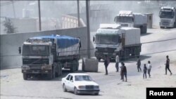 A convoy of aid trucks drives into Gaza from Rafah crossing, April 9, 2024, amid the ongoing conflict between Israel and the Palestinian Islamist group Hamas, in this screen grab taken from video.
