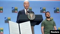 FILE - U.S. President Joe Biden speaks at an event, with G7 leaders and Ukraine’s President Volodymyr Zelenskyy, at right, in Vilnius, Lithuania, July 12, 2023. Biden wants G7 members to provide up to $50 billion in loans for Ukraine by using interest from frozen Russian assets.