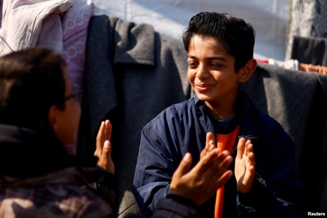 Displaced Palestinian teenager Hussam Al-Attar, nicknamed by people 'Newton', gestures at a tent camp in Rafah, in the southern Gaza Strip, February 6, 2024. (REUTERS/Ibraheem Abu Mustafa)