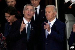 President Joe Biden and NATO Secretary-General Jens Stoltenberg watch a fly-over as they welcome NATO allies and partners to the White House in Washington, July 10, 2024, on the South Lawn for the 75th anniversary of the alliance.