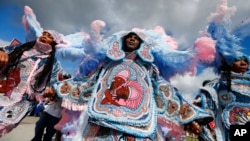 FILE - The Cheyenne and 7th Ward Creole Hunters Mardi Gras Indians are pictured at the New Orleans Jazz and Heritage Festival in New Orleans, May 4, 2017. (AP Photo/Gerald Herbert)