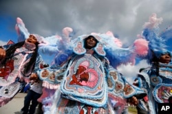 FILE - The Cheyenne and 7th Ward Creole Hunters Mardi Gras Indians are pictured at the New Orleans Jazz and Heritage Festival in New Orleans, May 4, 2017.