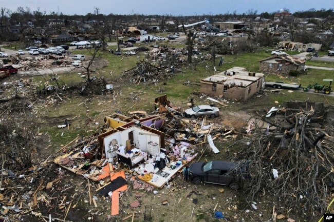 Debris is strewn around tornado damaged homes, Sunday, March 26, 2023, in Rolling Fork, Miss. (AP Photo/Julio Cortez, File)