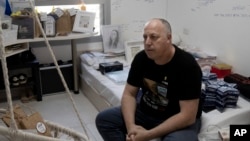 Shlomi Berger sits in his daughter's bedroom in Holon, Israel, April 17, 2024.