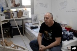 FILE—Shlomi Berger sits in his daughter's bedroom in Holon, Israel, April 17, 2024. Agam, 19, was abducted two days after the start of her army service along the border with Gaza on October 7, 2023.