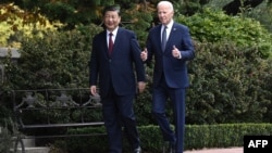 FILE — Chinese President Xi Jinping, left, and U.S. President Joe Biden walk together at the Filoli Estate in Woodside, California, during the Asia-Pacific Economic Cooperation leaders' week, Nov. 15, 2023. The two are scheduled to have a phone call in the spring.