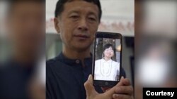 唐吉田律師和他手機裡女兒的照片，2021年拍攝。(唐吉田律師關注組提供)