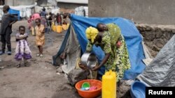 FILE - Congolese woman and children reside in a camp for internally displaced people in Kanyaruchinya near Goma, North Kivu province of the Democratic Republic of Congo, Feb. 16, 2023.