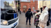 In this still frame taken from video, activists temporarily obstruct a police bus holding detained journalists from leaving the site where they were reporting on a group of women demanding the return of husbands who were mobilized to fight in Ukraine, in Moscow on Feb. 3, 2024.