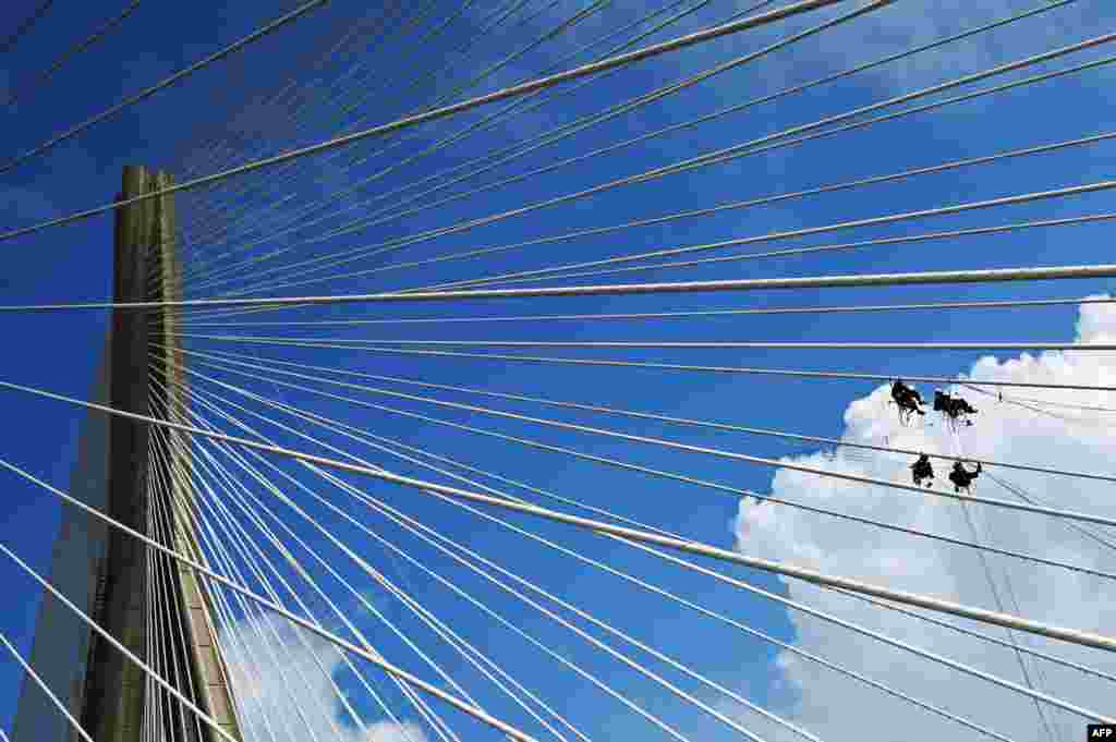 Workers conduct maintenance work on the Bandra-Worli Sea Link in Mumbai, India.