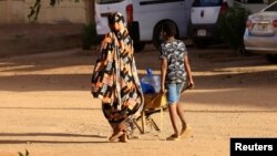 People look for water during clashes between the paramilitary Rapid Support Forces and the army in Khartoum North, Sudan, April 20, 2023. 