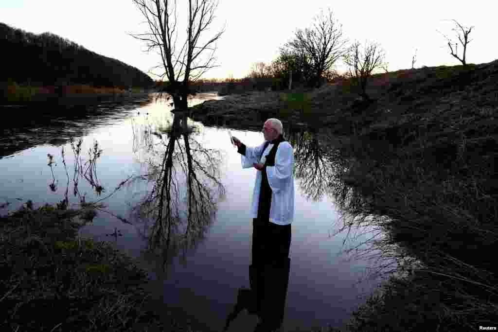 Reverend Rob Kelsey holds the annual Blessing of the Salmon service at Pedwell Landings in Norham, Britain.