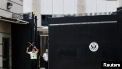 美国驻香港领事馆遭涂鸦被清洗后，一名保安站在领事馆大门外。（2023年6月13日）