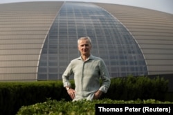 The Artistic Director of the Bolshoi Ballet Makhar Vaziev poses for a picture in front of the National Centre for the Performing Arts, a day before the Russian ballet company's performance in Beijing, China, July 24, 2023. (REUTERS/Thomas Peter)
