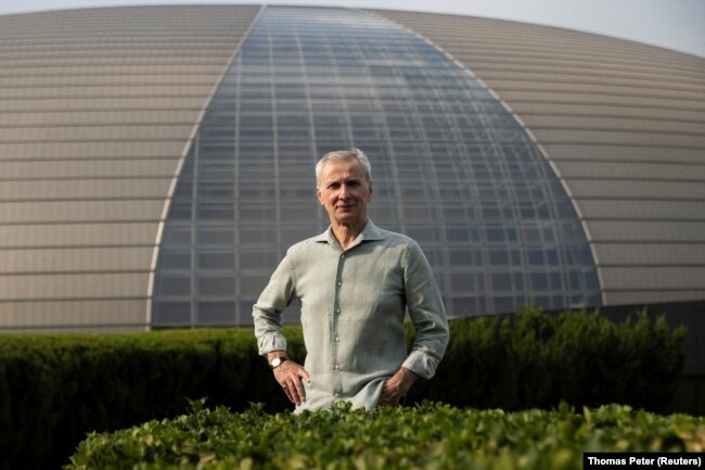 The Artistic Director of the Bolshoi Ballet Makhar Vaziev poses for a picture in front of the National Centre for the Performing Arts, a day before the Russian ballet company's performance in Beijing, China, July 24, 2023. (REUTERS/Thomas Peter)