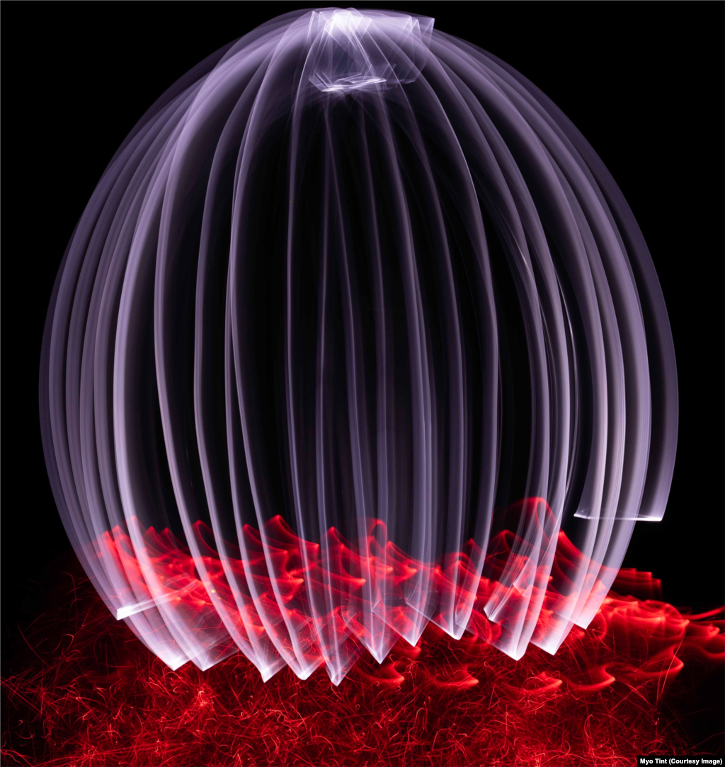 A light painting created by a torch light with a diamond plexiglass for the white orb and fiber optic lights to create smoke and fire effects under the orb is displayed at the Performing Art studio in Coleg Menai, North Wales, UK, July 18, 2023.
