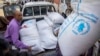 (FILE) Displaced Yemenis receive humanitarian aid provided by the World Food Programme (WFP) in the city of Taiz on September 11, 2023. 