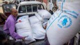 (FILE) Displaced Yemenis receive humanitarian aid provided by the World Food Programme (WFP) in the city of Taiz on September 11, 2023. 