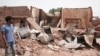 A man walks by a house hit in recent fighting in Khartoum, Sudan, April 25, 2023.