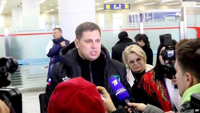 A Russian tourist speaks to the media as a group of Russian tourists, likely the first foreign travelers from any country to enter North Korea since the pandemic arrive at the Pyongyang International Airport in Pyongyang, North Korea, Feb. 9, 2024.