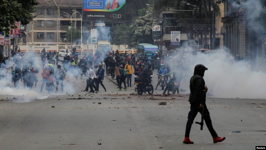 A police officer walks after using tear gas to disperse protesters during a demonstration over police killings of people protesting against Kenya's proposed finance bill 2024/2025, in Nairobi, June 27, 2024. 
