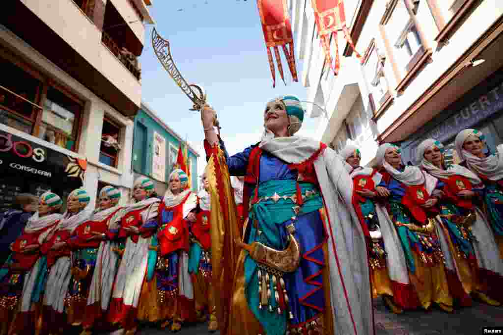 A "Comparsa of Muslims" takes part in the "Moorish entrance" parade during the Moors and Christians festival in Elda, in the south of the province of Alicante, Spain, June 16, 2024. 