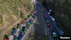 A drone photo shows Polish farmers blocking the A2 motorway to protest over price pressures, taxes and green regulation and against the import of agricultural products from Ukraine, near the Polish-German border near Swiecko, Poland, Feb. 25, 2024.