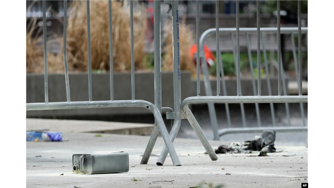 A metal can sits on the ground at the scene where a man lit himself on fire in a park outside Manhattan criminal court in New York, April 19, 2024.