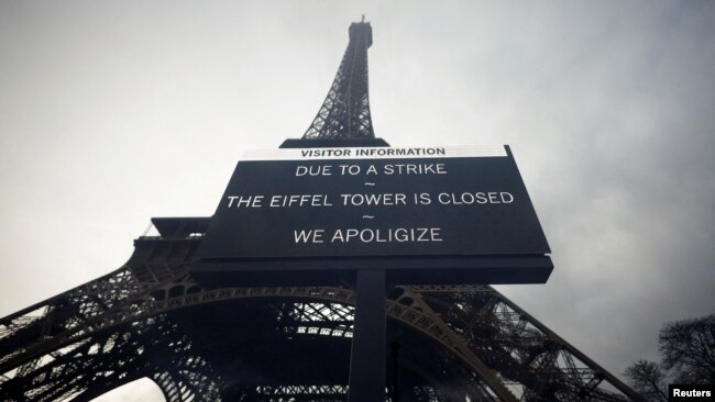 A sign accouncing the closing of the Eiffel Tower due to a strike is seen in front of the 19th century landmark in Paris, France, Feb. 19, 2024.