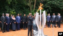 Rwandan President Paul Kagame lights a memorial flame during a ceremony to mark the 30th anniversary of the Rwandan genocide, held at the Kigali Genocide Memorial, in Kigali, Apr. 7, 2024. 