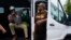 FILE - UPS teamsters and workers wait before a rally in Atlanta, July 21, 2023. UPS reached a contract agreement with its 340,000-person strong union July 25, averting a strike.
