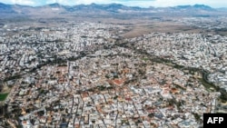 FILE - This picture taken on December 8, 2023 shows an aerial view of the divided walled city of Cyprus' capital Nicosia and the city center in the area controlled by the Republic of Cyprus in the foreground.