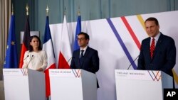 From left, German Foreign Minister Annalena Baerbock, French Foreign Minister Stephane Sejourne and Polish Foreign Minister Radoslaw Sikorski speak to reporters at the Chateau de La Celle Saint-Cloud near Paris, Feb. 12, 2024.